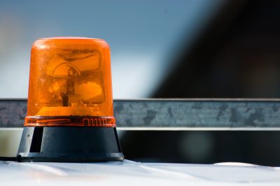Orange flashing and revolving light on top of a support and services vehicle